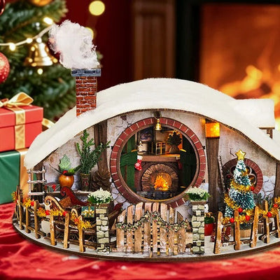 Maison Miniature Magic Ring Snow House près d'une cheminée